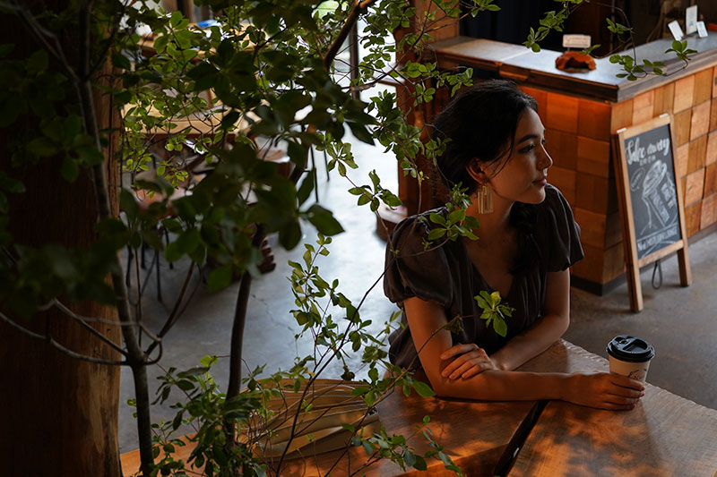 Image of model in dim cafe setting