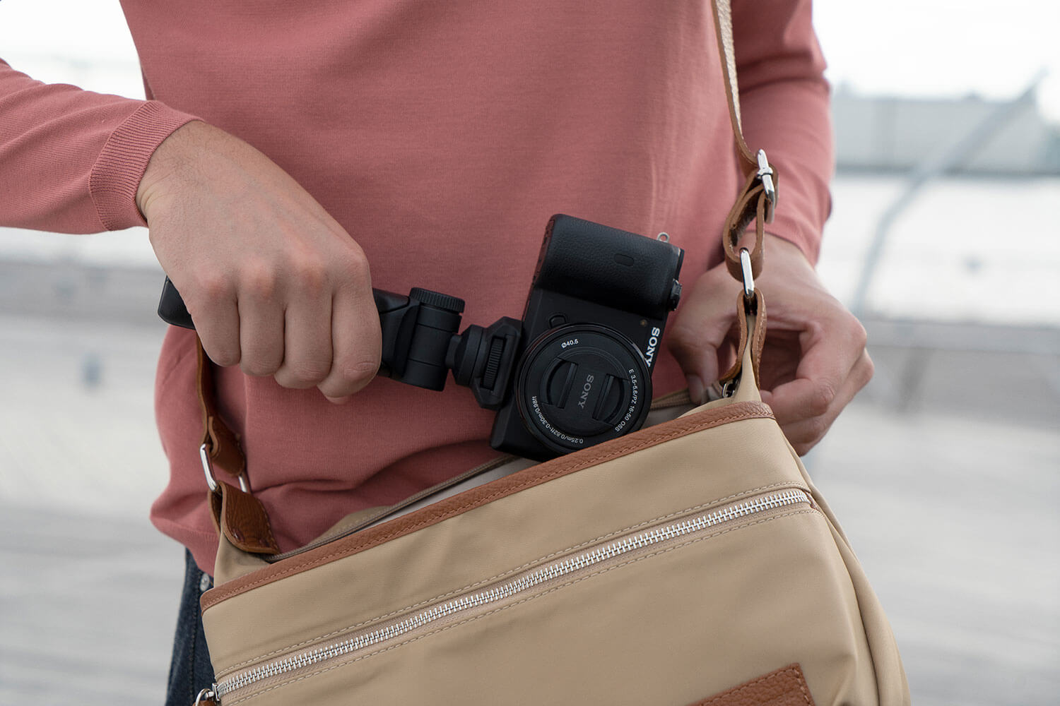 Image of camera on shooting grip being placed into carry bag