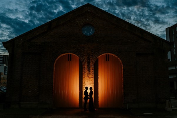 Wedding Photography - Wedding couple standing in front of a church