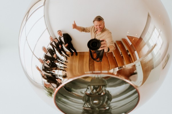 Wedding Photography - Reflection of photographer and wedding guests