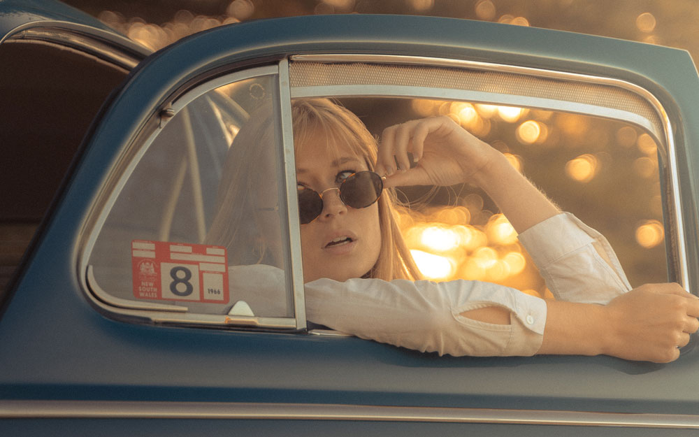Automotive Photography - Photo of woman with sunglasses inside a car with the door open