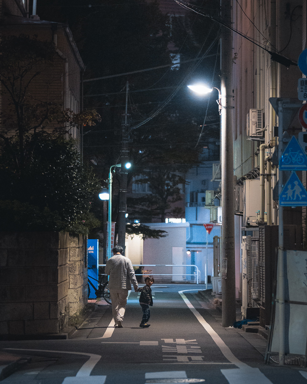 Street Photography - Adult and child walking down the street