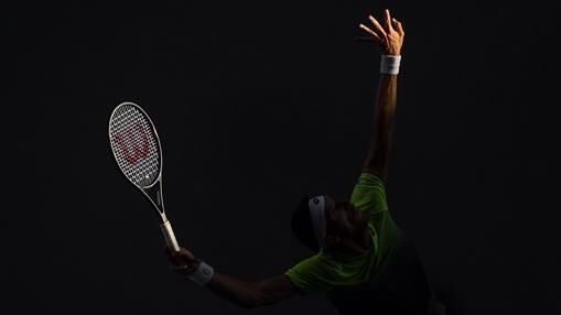 "Sea of darkness"- This image was captured in “magic light” when Leonardo Mayer of Argentina raises his hand and racket to serve.