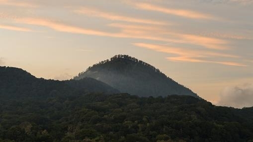 A lonely peak at dawn, near twin lakes on the island of Bali.